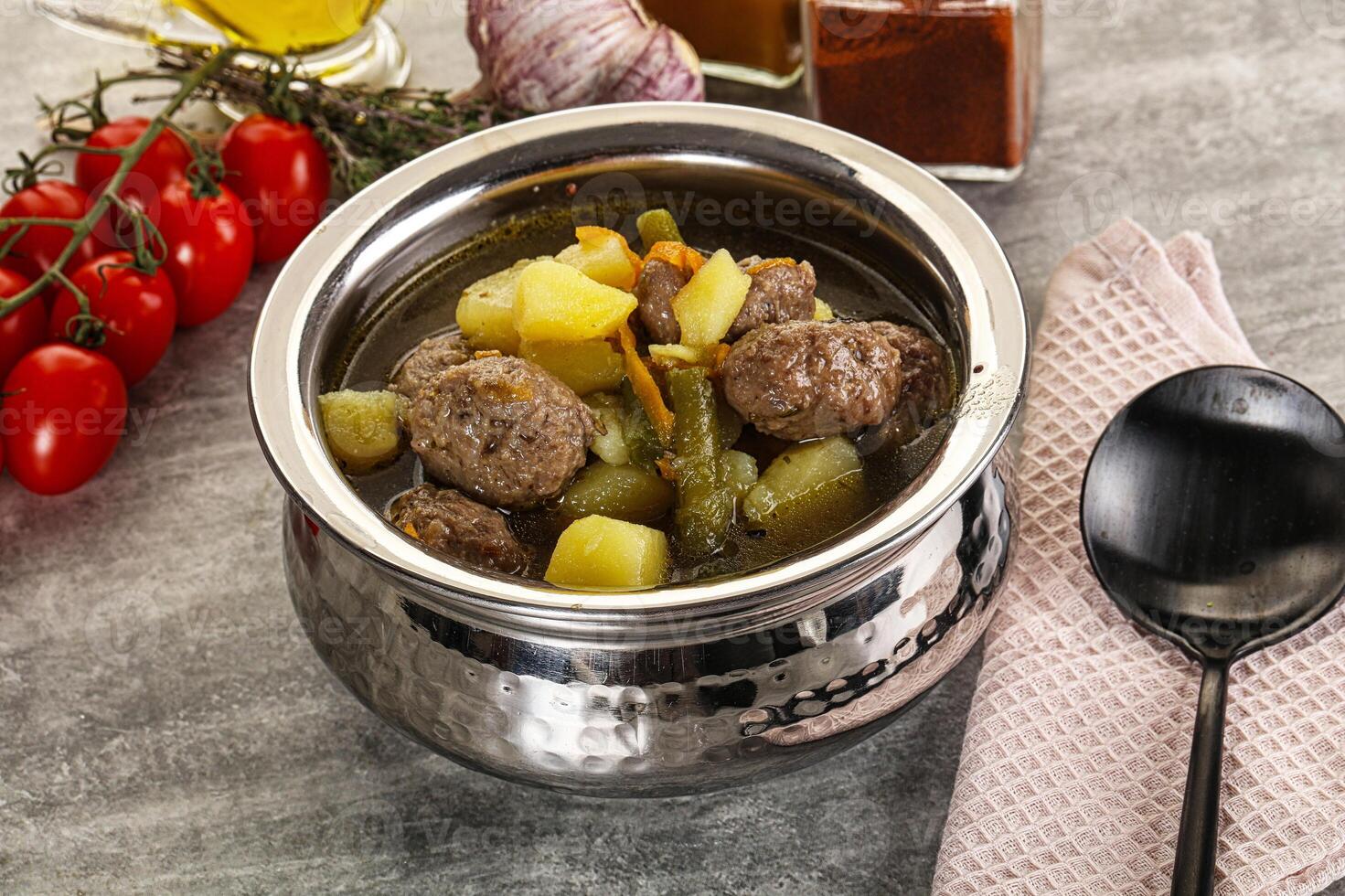 A silver pot with meat and vegetables in it photo