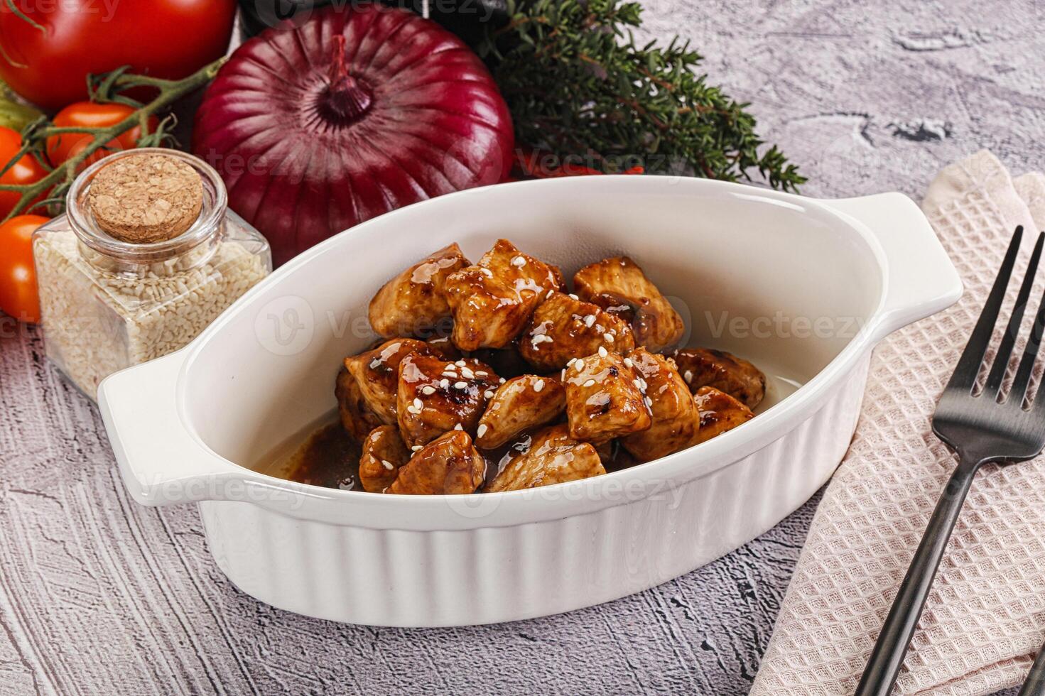 A white bowl with meat and vegetables on a table photo