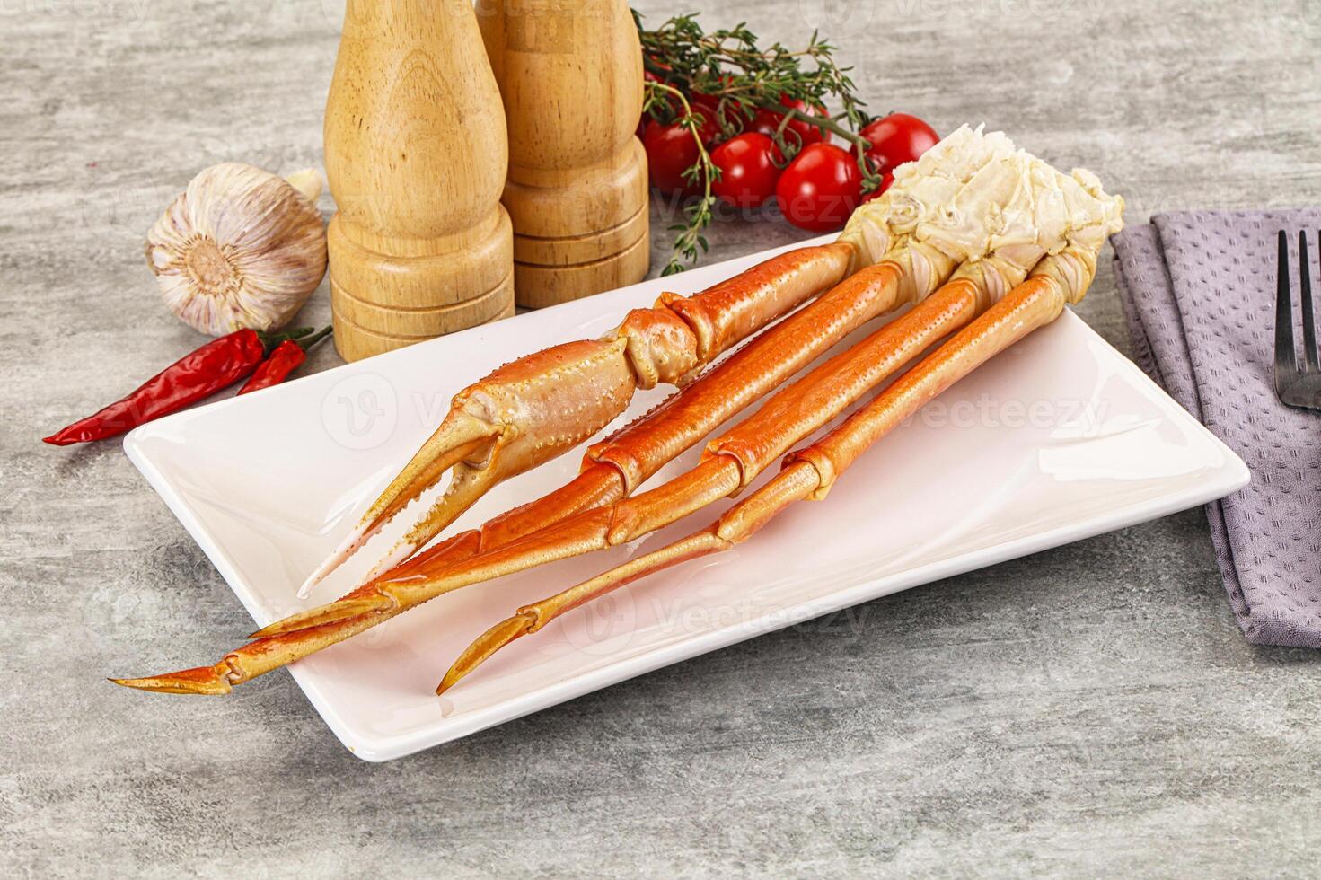 A plate with two crab legs on it photo