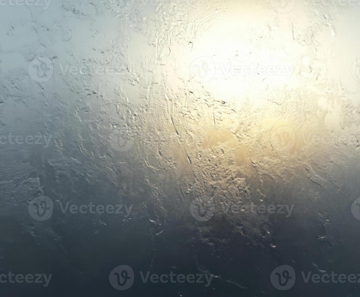 Light filtering through a foggy window at dawn photo