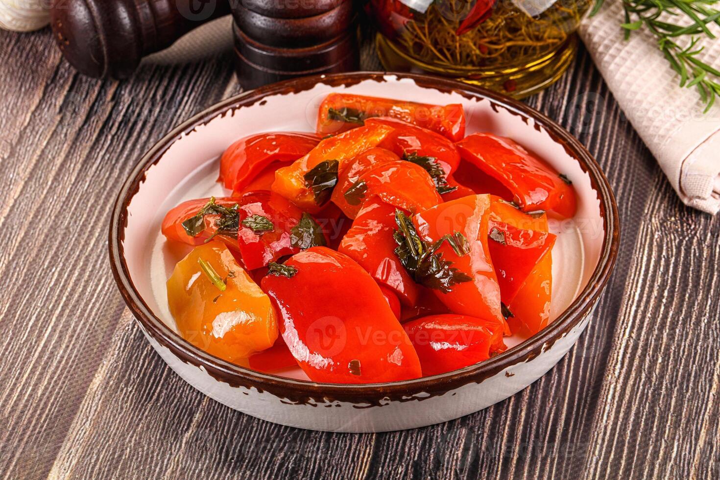 A bowl of peppers and herbs on a table photo