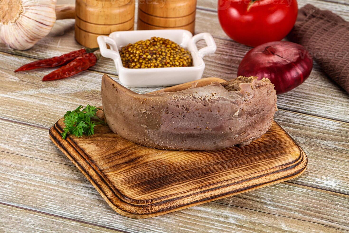 A piece of meat on a wooden cutting board photo