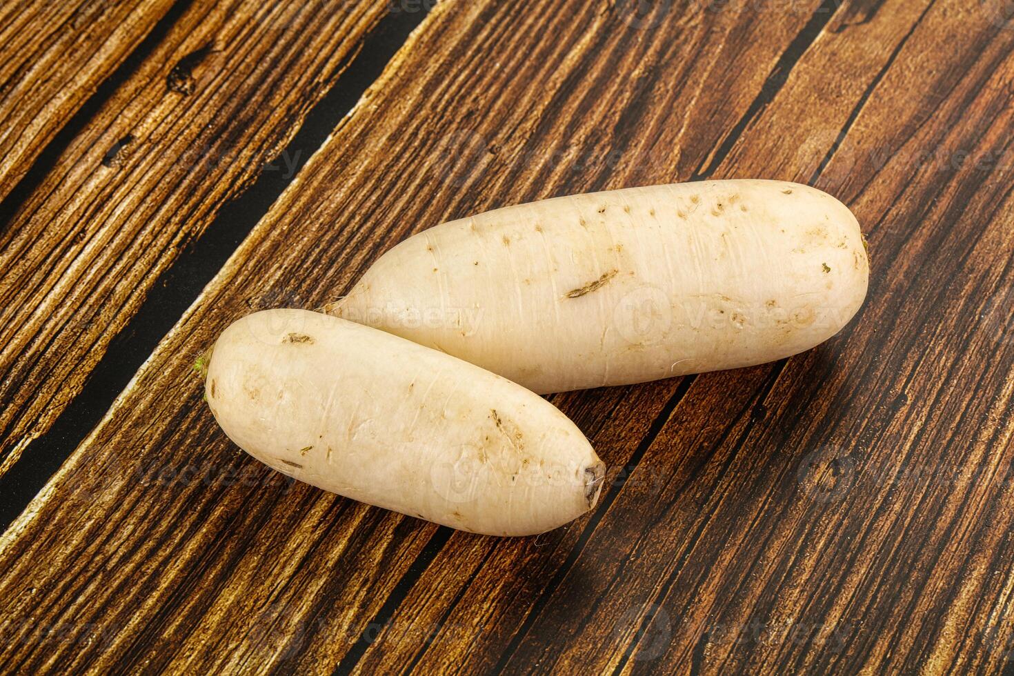 Two white potatoes on a wooden table photo