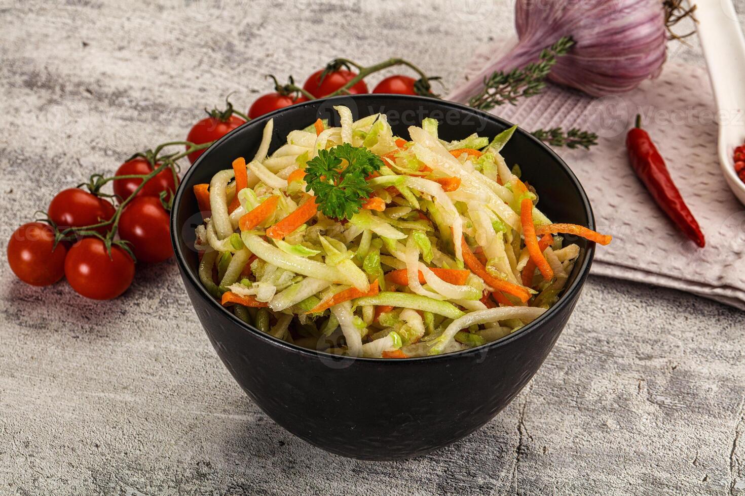 A bowl of vegetables and a knife on a table photo