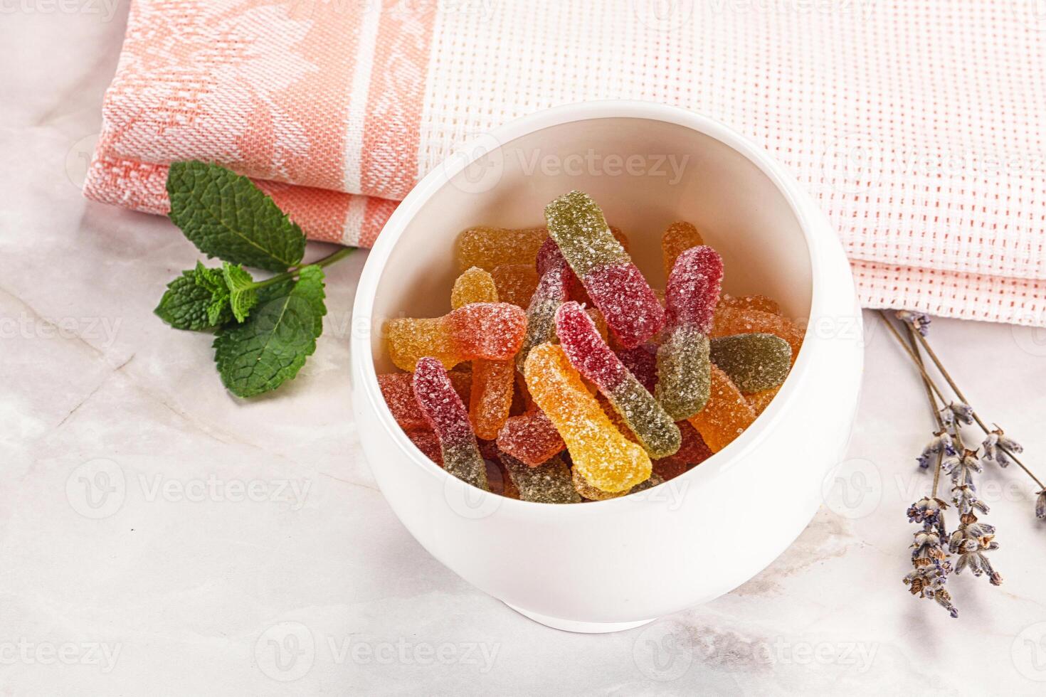 A bowl filled with gummy bears and mint photo