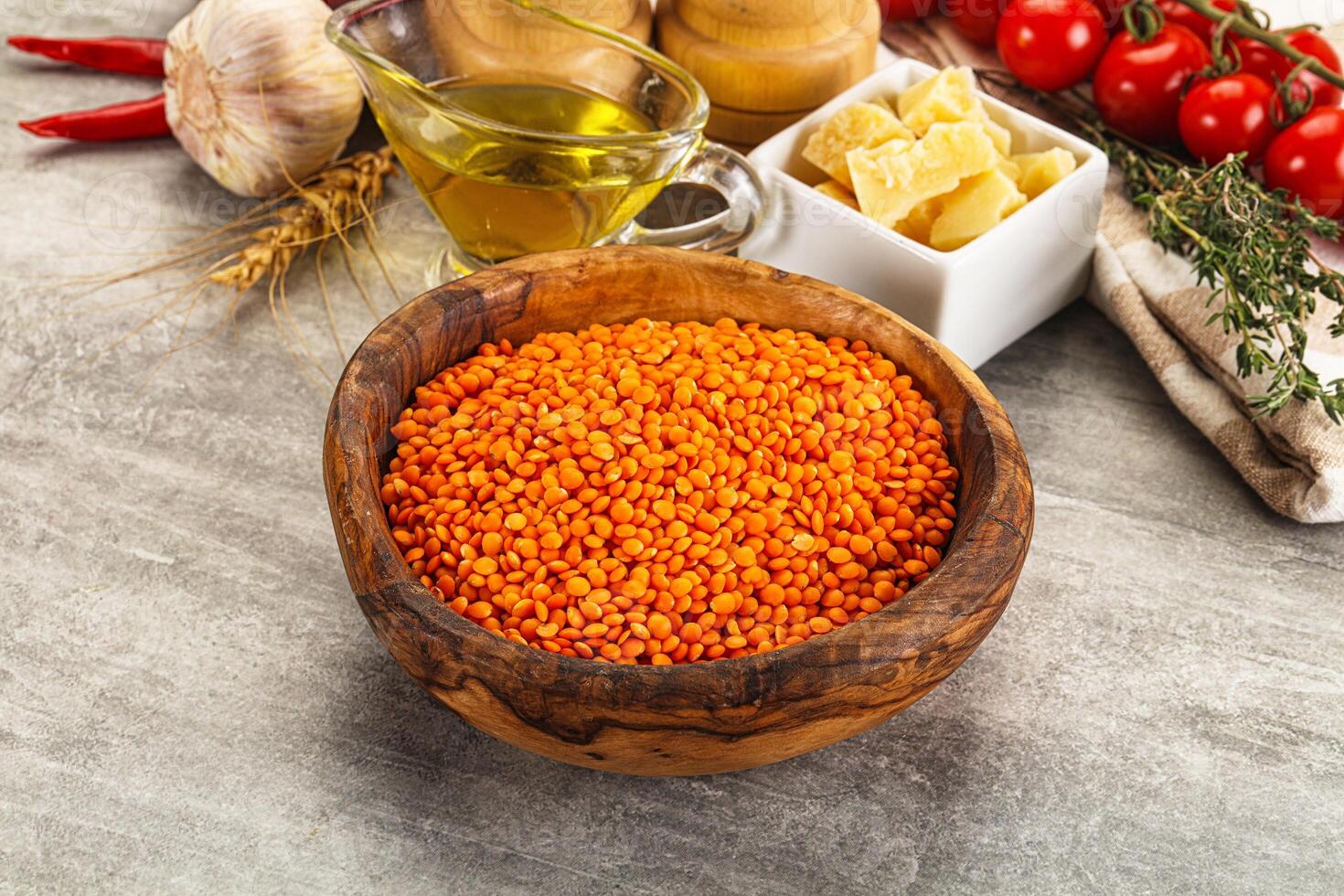 A bowl of red lentils, a bowl of tomatoes, and a bowl of garlic photo