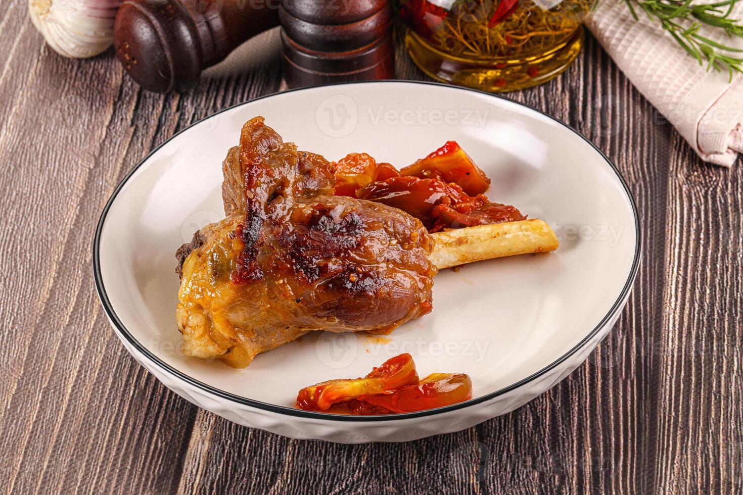 A plate of food with a knife and a bottle of wine photo