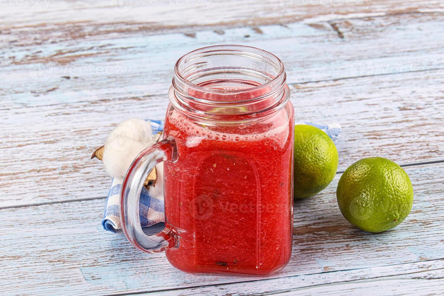 A glass jar with a lime and watermelon in it photo