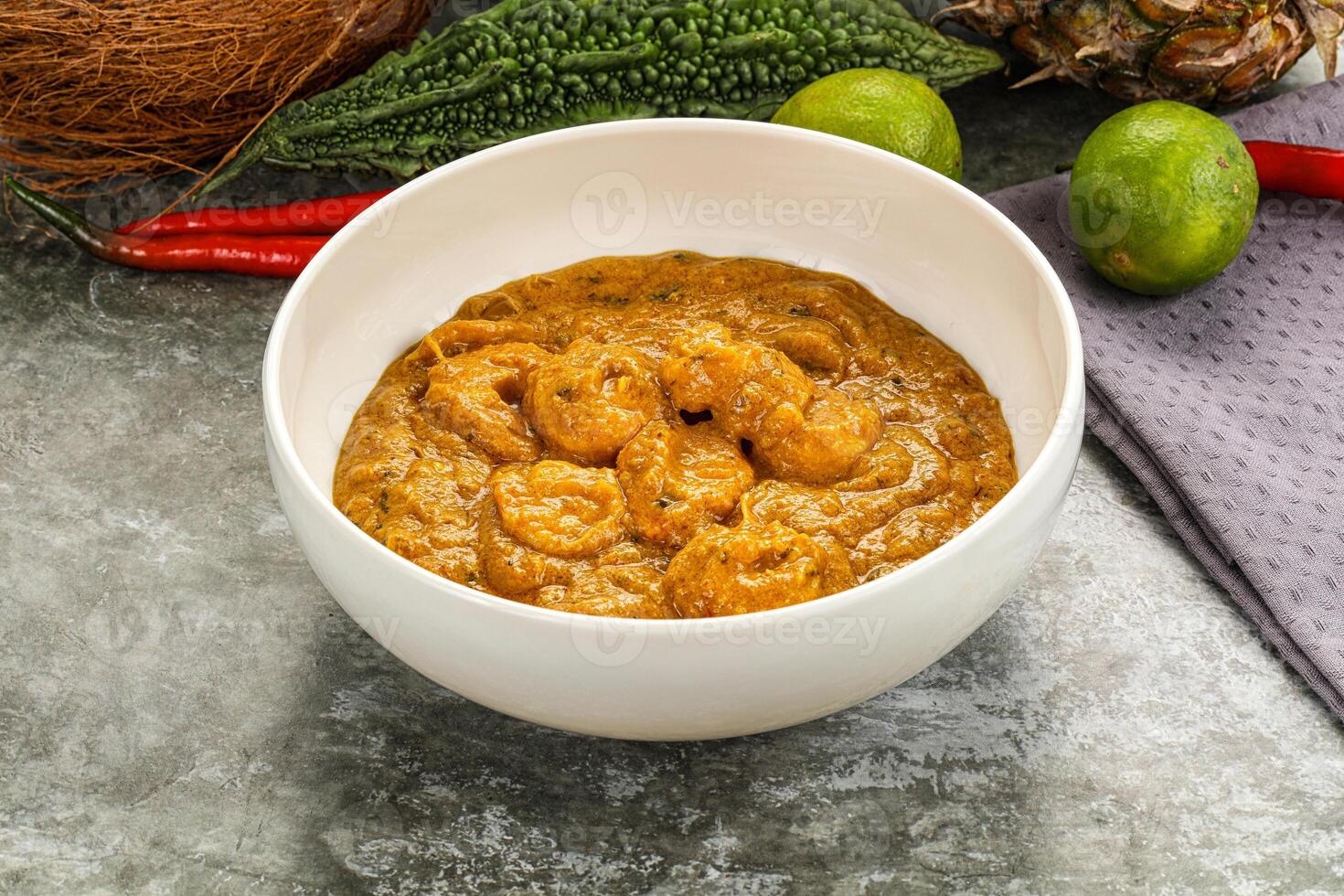 A bowl of food with a coconut and some other ingredients photo
