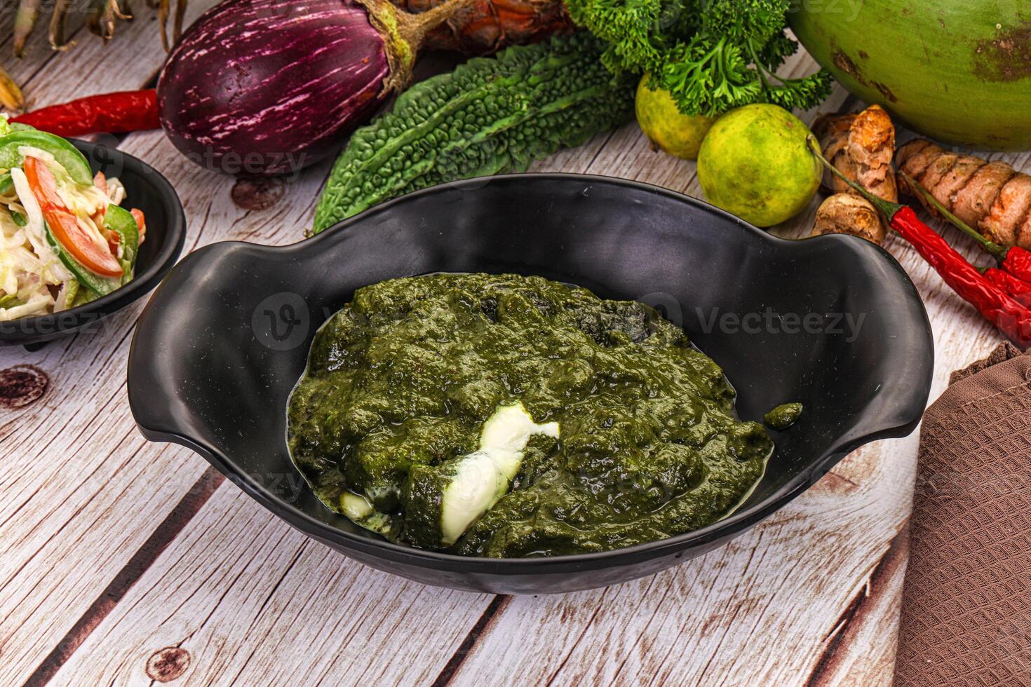 A bowl of green food on a table photo