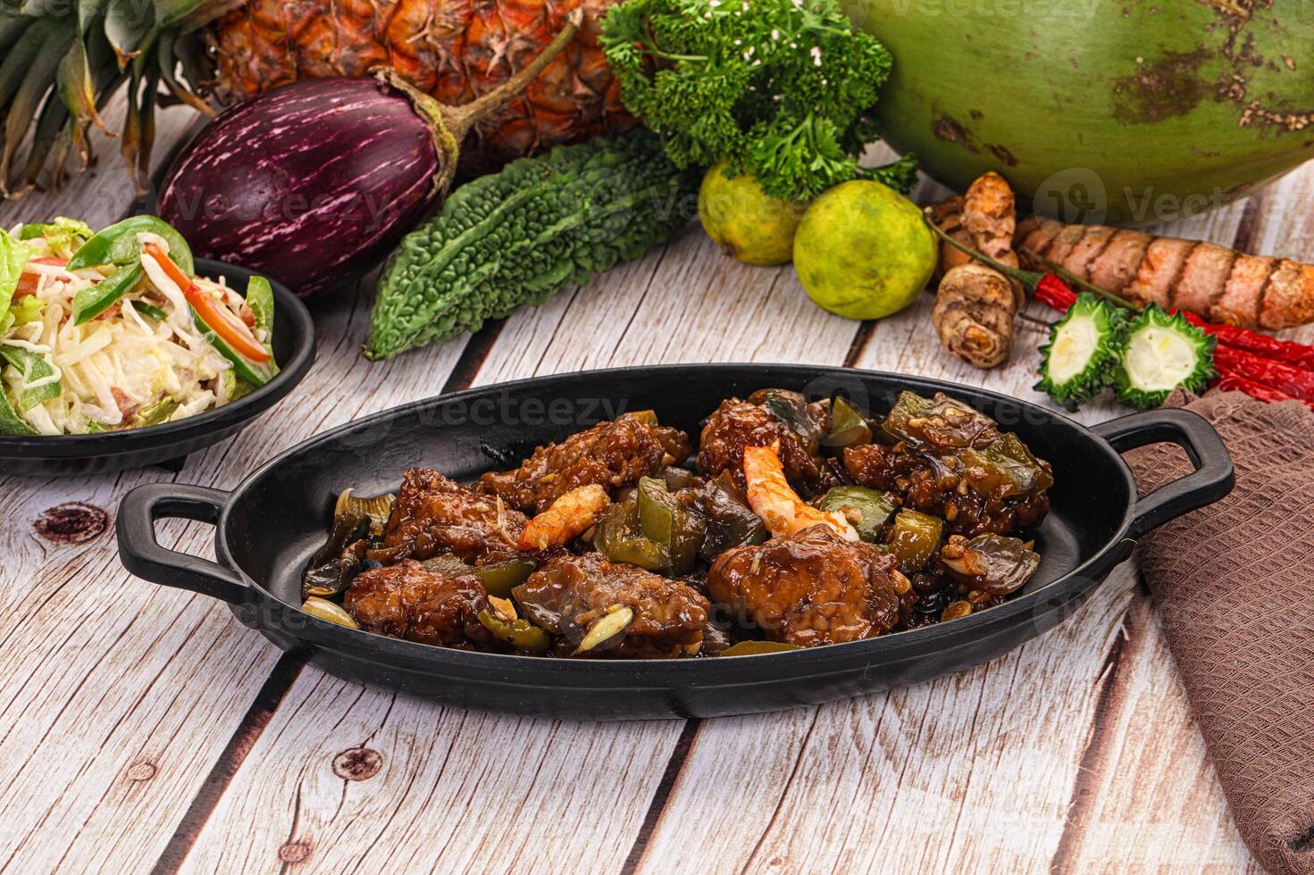 A table with a bowl of food and a bowl of vegetables photo