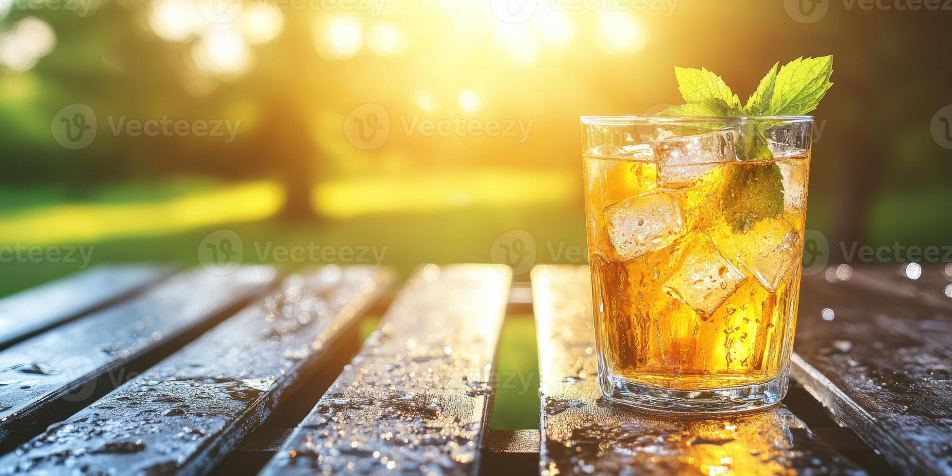 Refreshing beverage in a sunlit outdoor setting by greenery photo