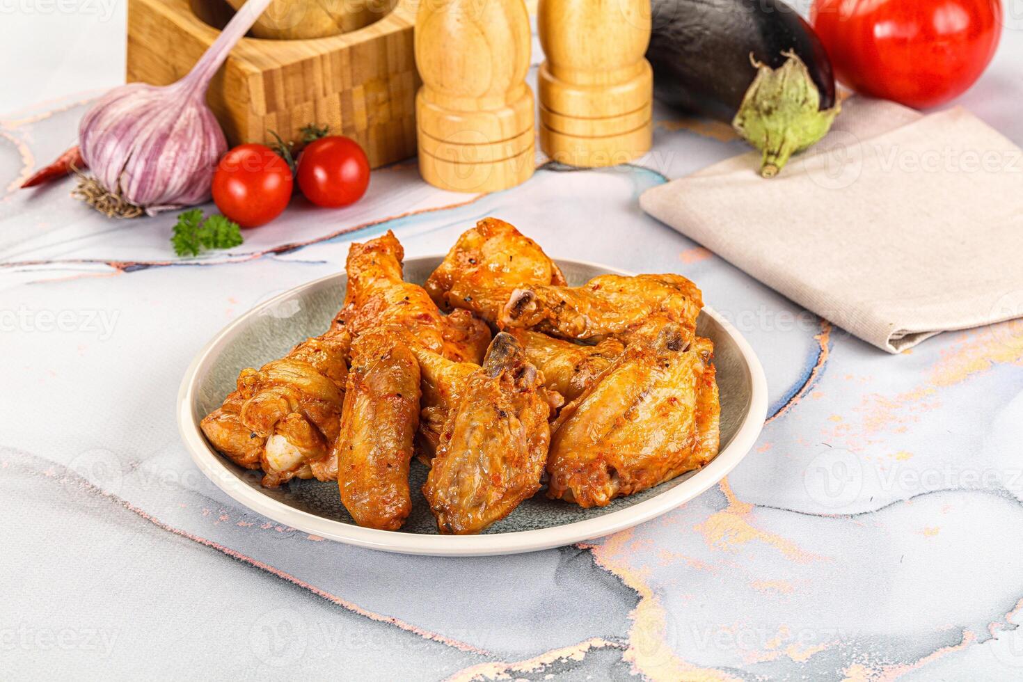 A plate of chicken wings on a marble counter photo