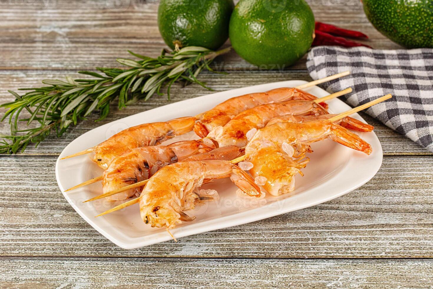 Grilled shrimp on a plate with herbs and spices photo