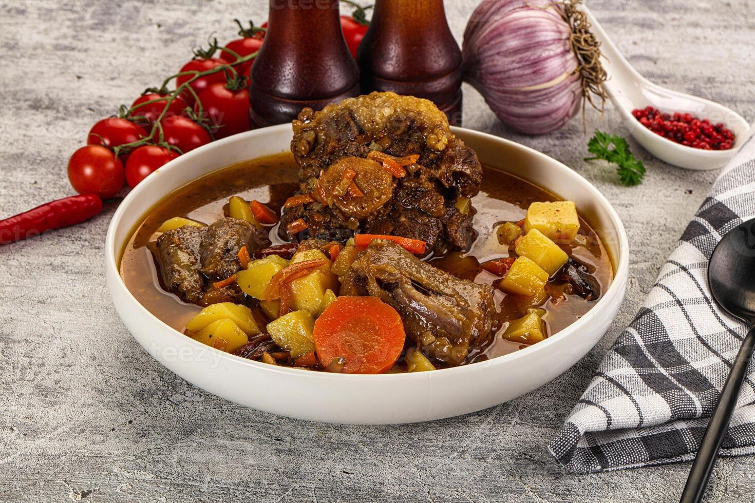 A bowl of stew with vegetables and meat photo