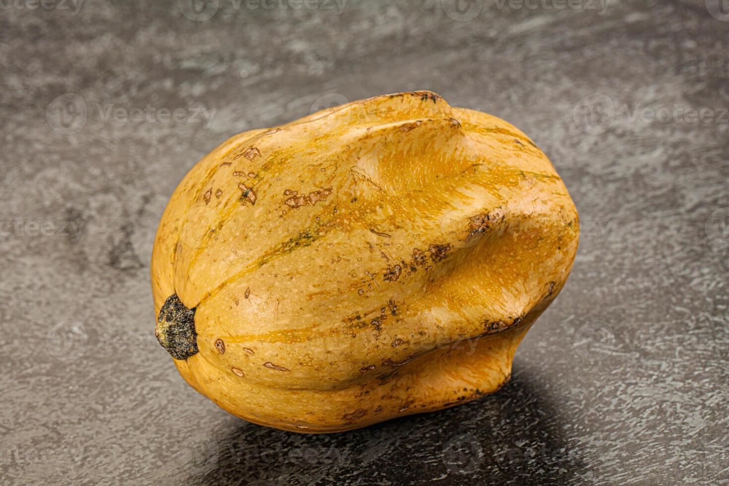 A yellow squash on a table photo
