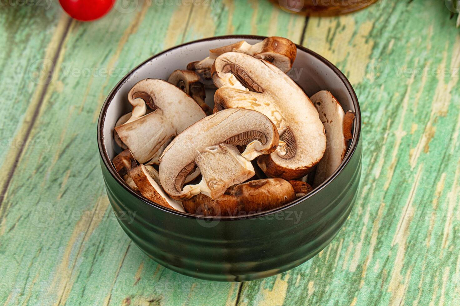 Mushrooms in a bowl on a wooden table photo