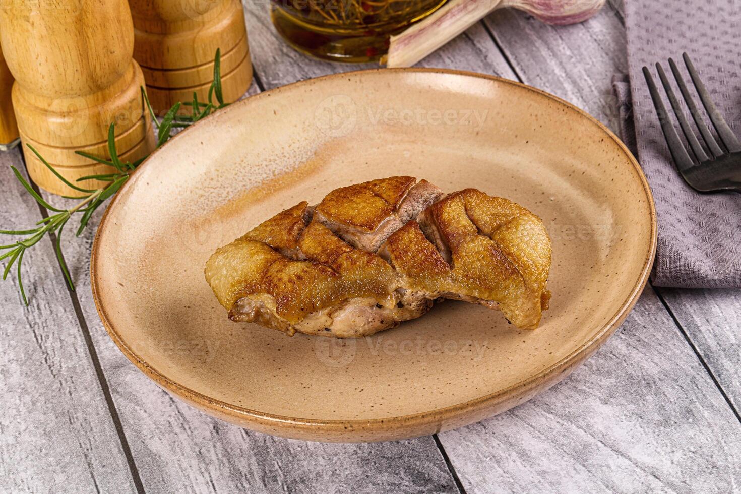 A plate with a piece of meat on it photo