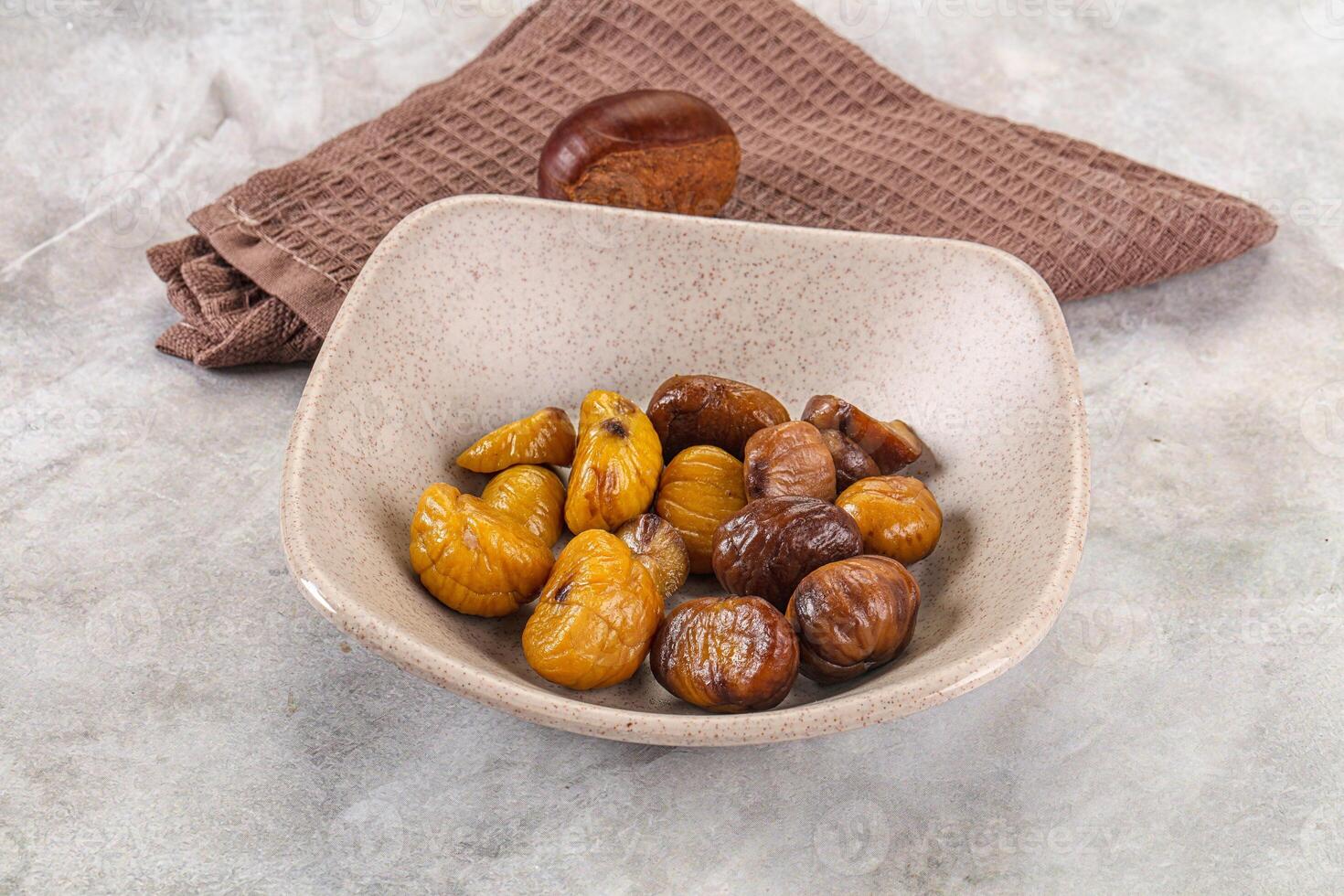 A bowl of dried dates and a towel on a table photo