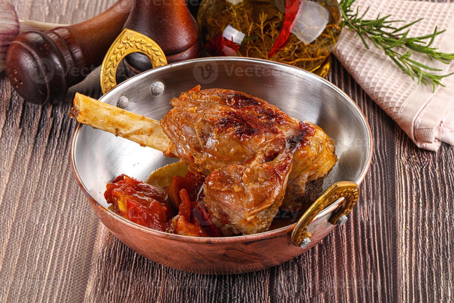 A pan with meat and vegetables in it photo