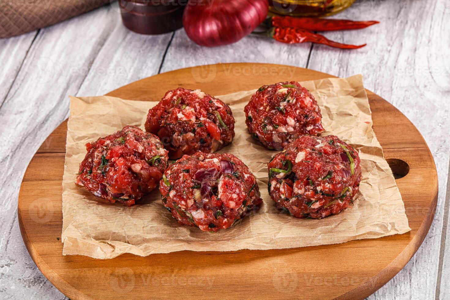 Meatballs on a wooden cutting board with spices photo