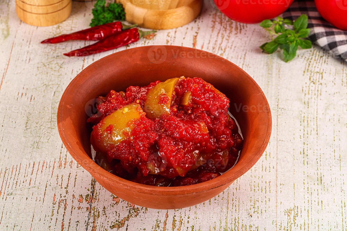 A bowl of tomato sauce with peppers and tomatoes photo