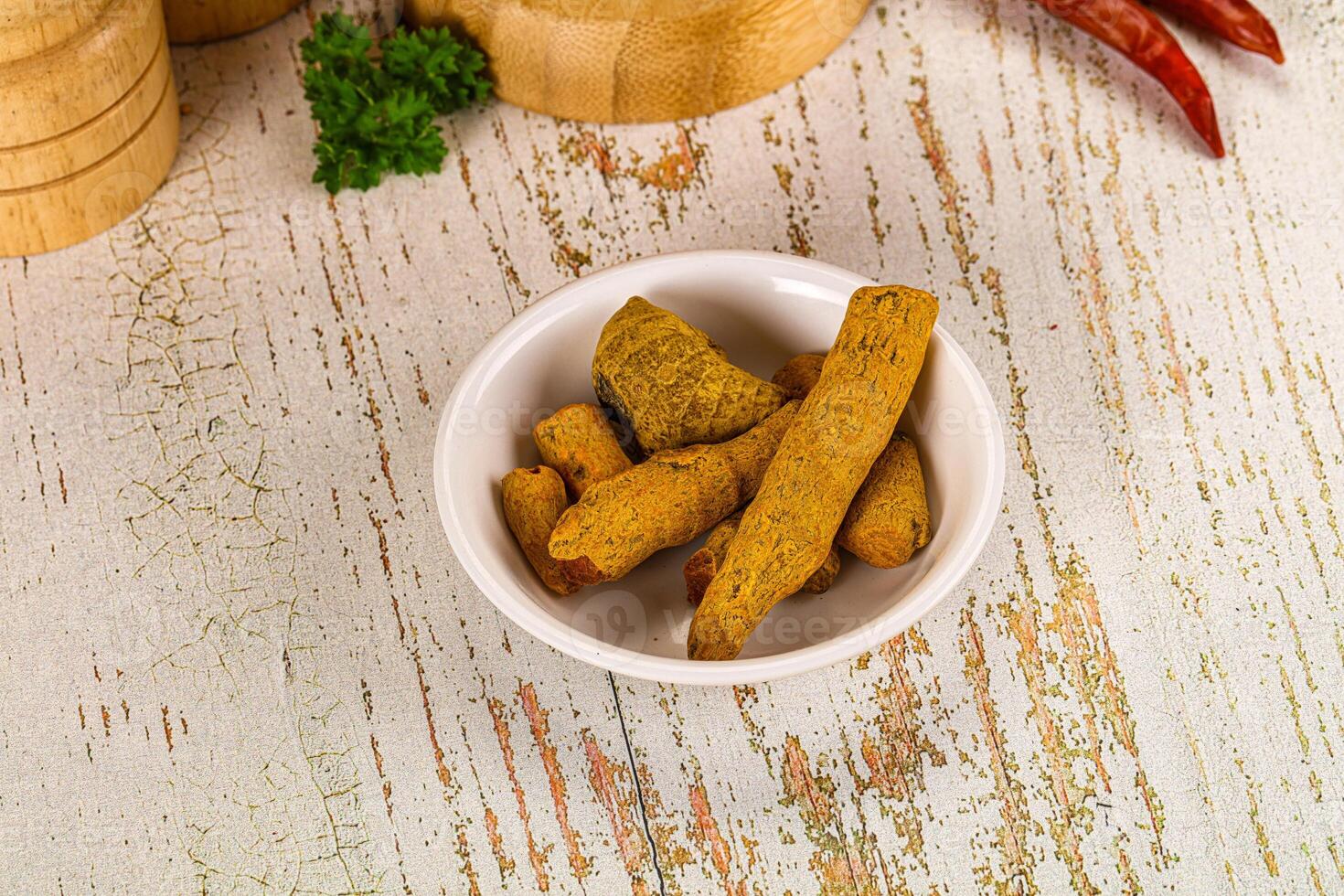 A bowl of food on a table with a wooden bowl and a wooden spoon photo