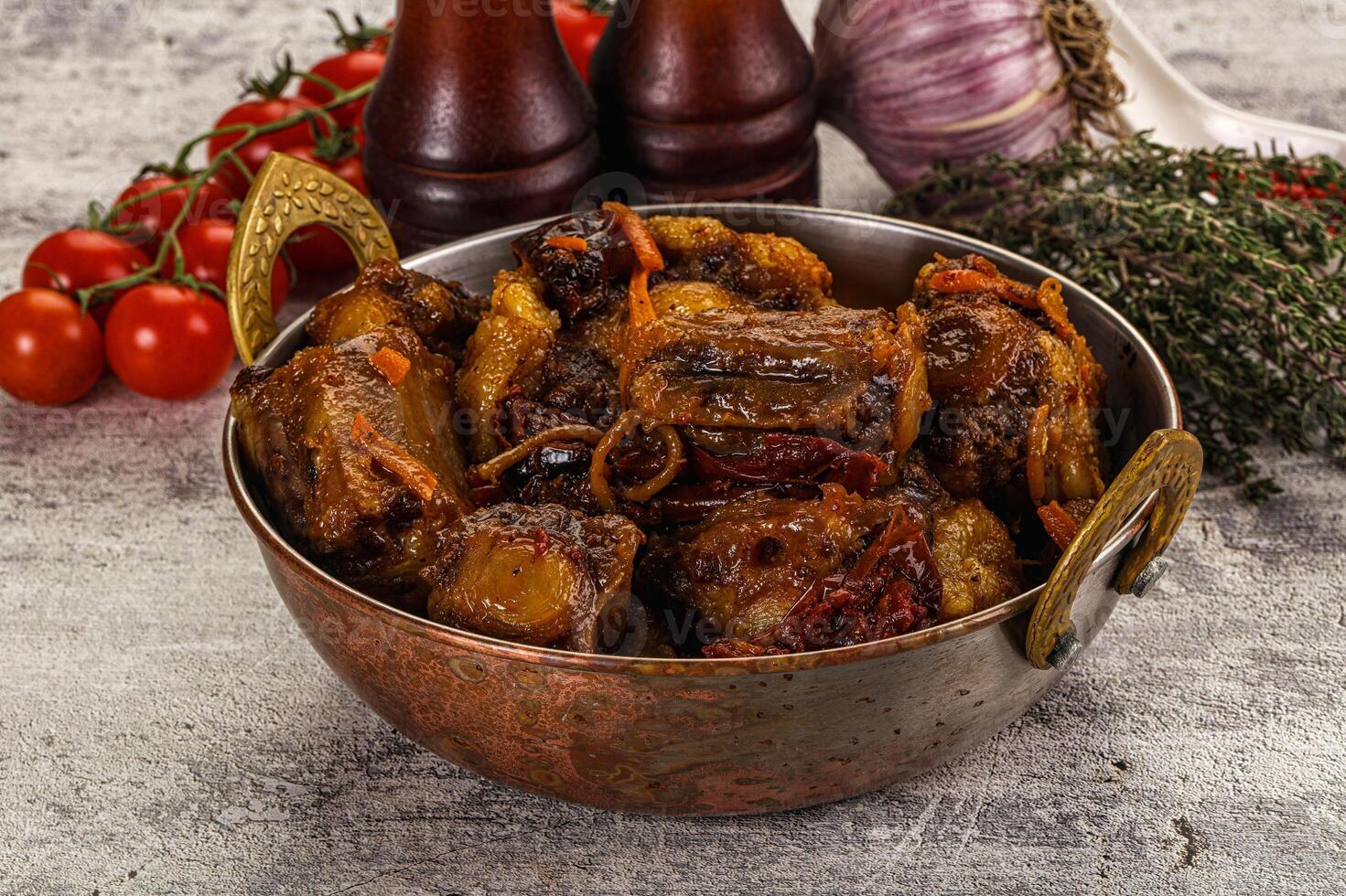 A bowl filled with meat and vegetables on a table photo