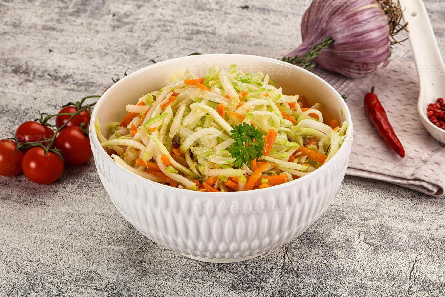 A bowl of coleslaw with tomatoes and onions photo