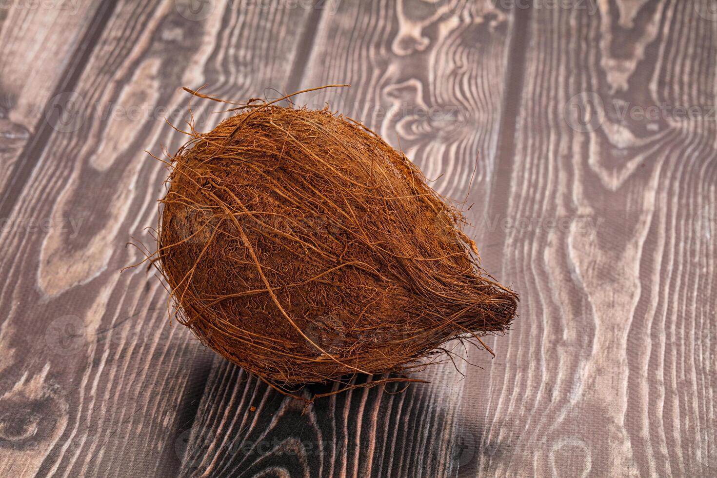 A coconut on a wooden table photo