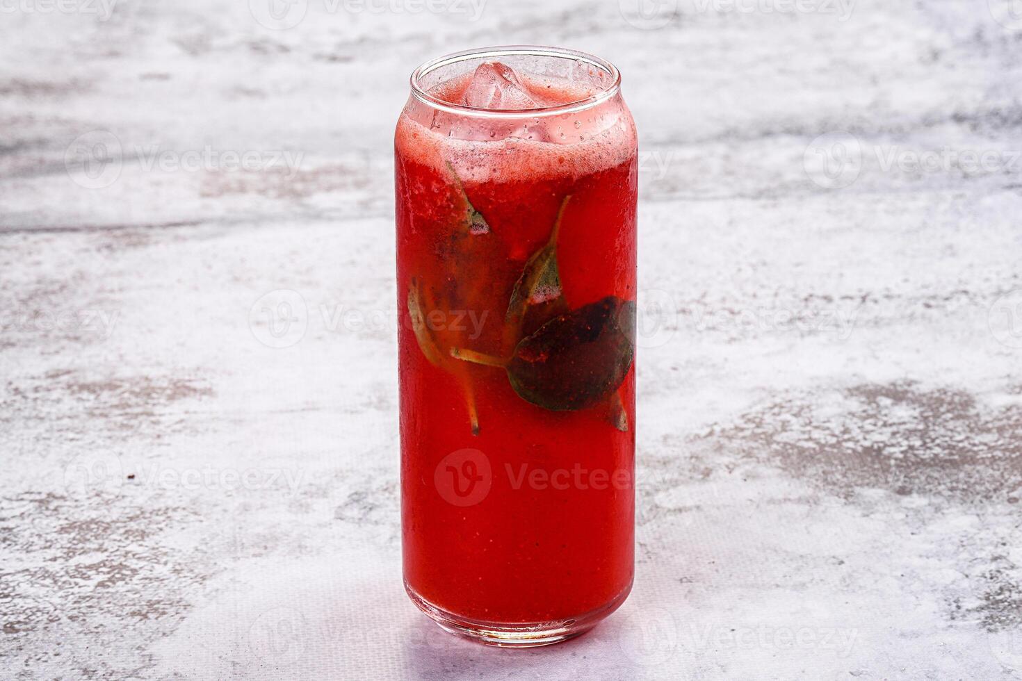 A red drink with a leaf in it photo