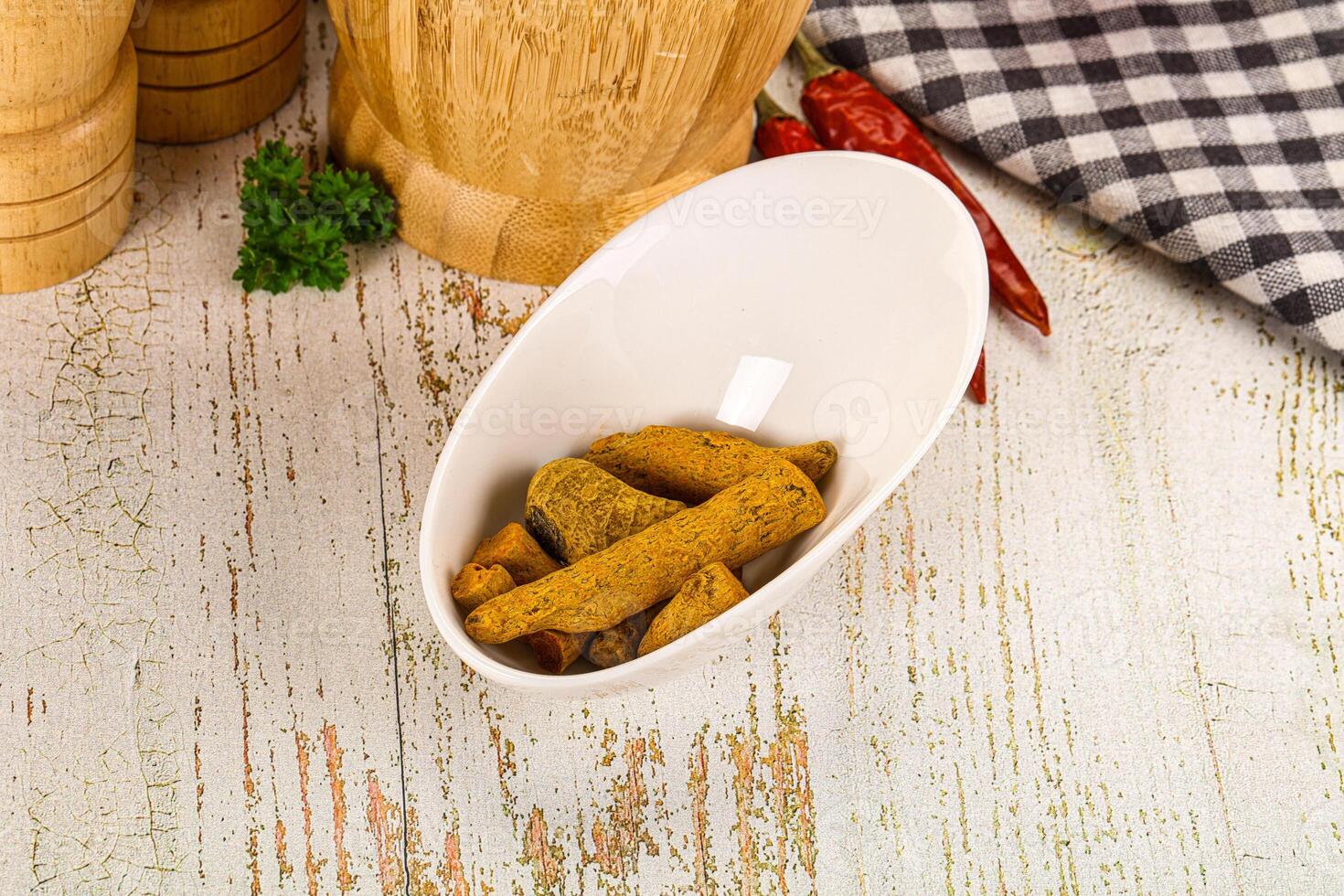 A bowl of food on a table next to a knife photo
