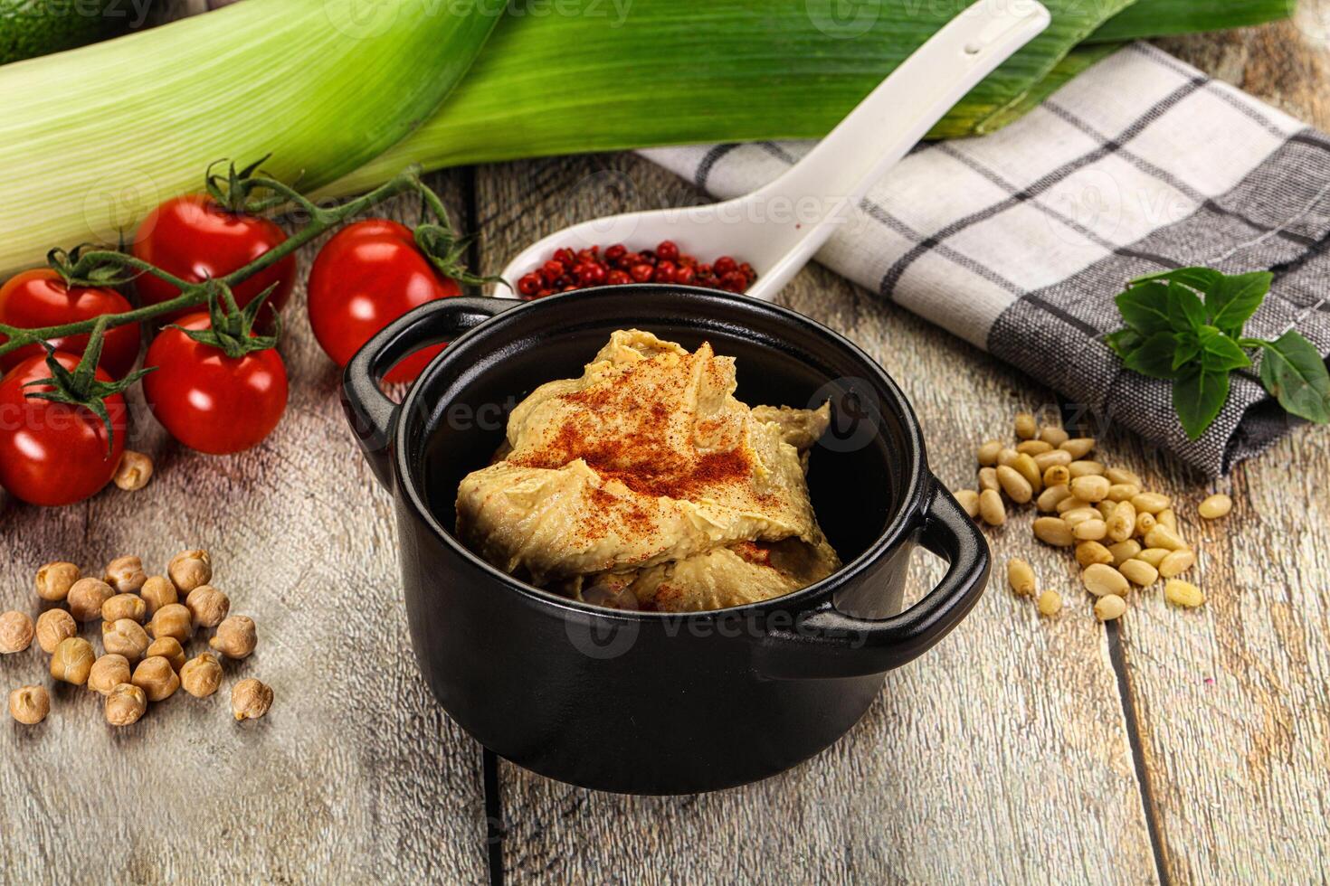 A bowl of food with a spoon and a knife photo
