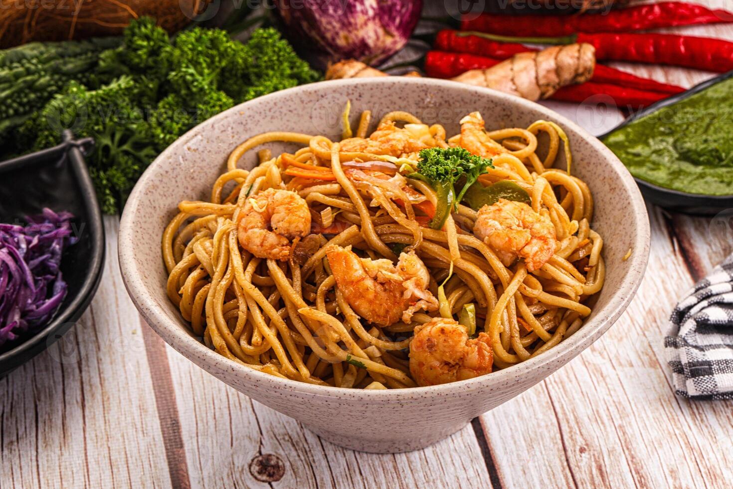 A bowl of noodles with shrimp and vegetables photo