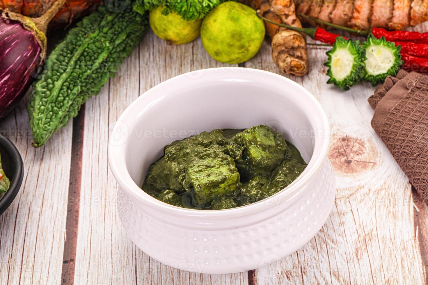 A bowl of green food on a table photo