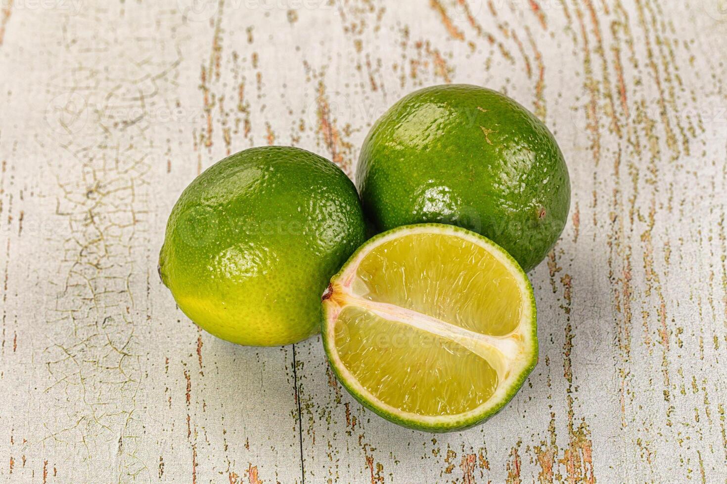 Three limes on a wooden surface photo