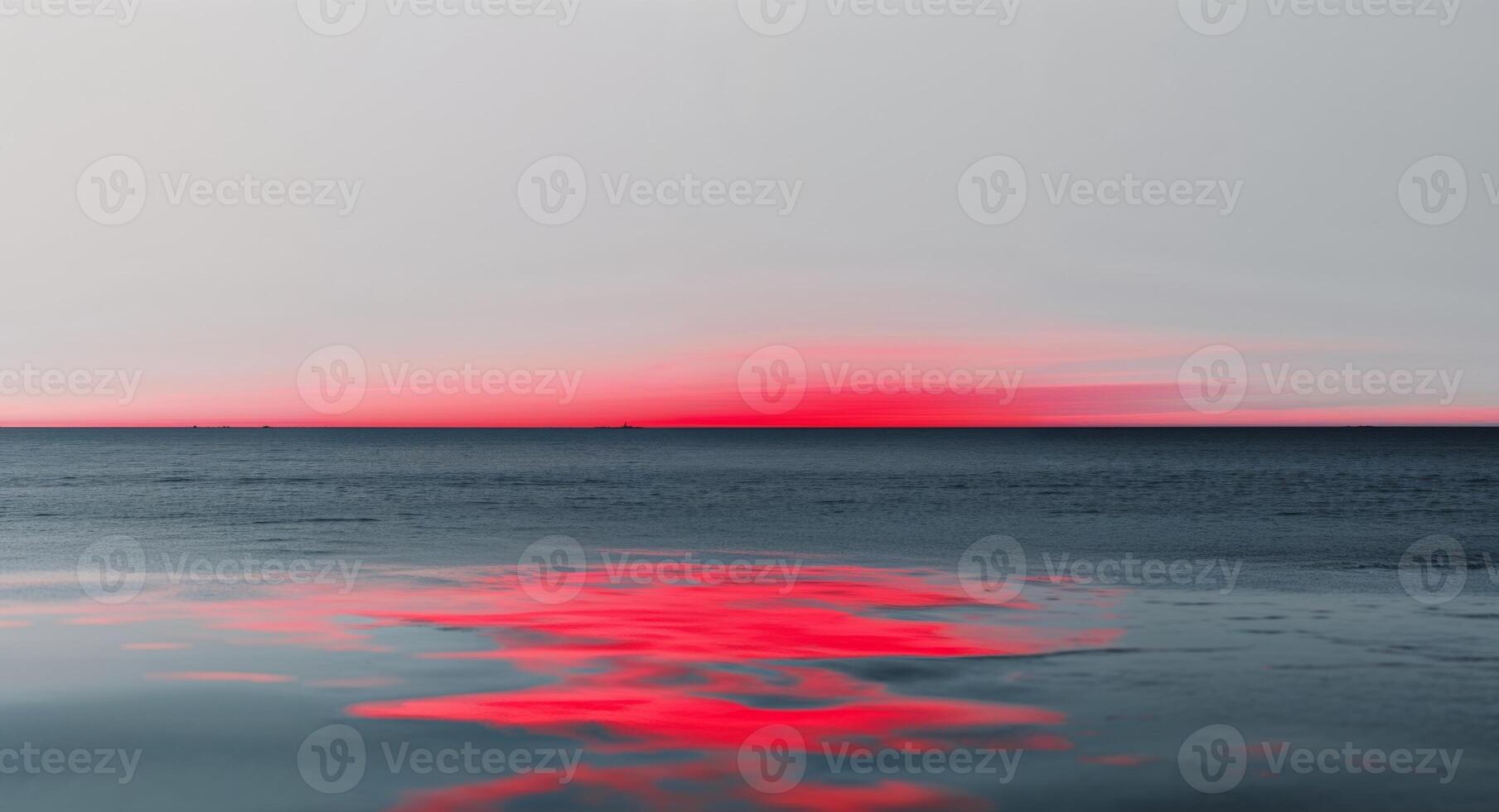 A red sky and water with a reflection photo