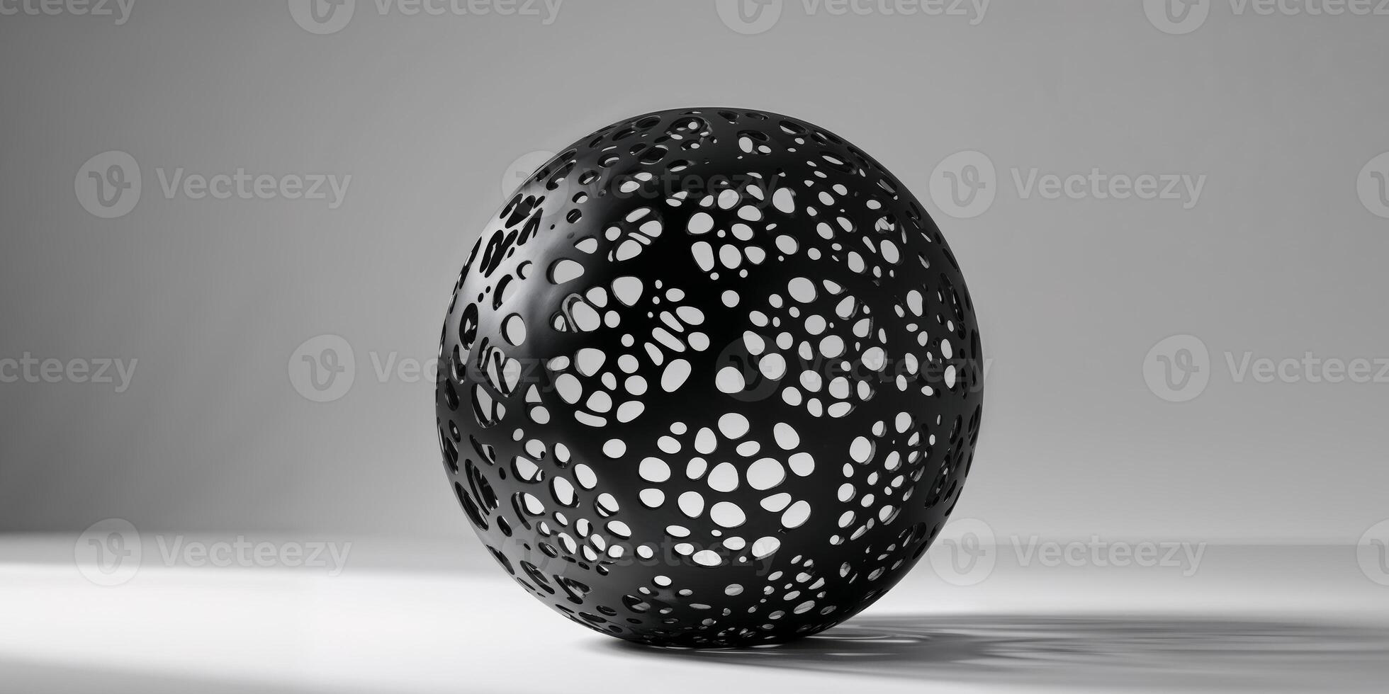 Unique Black Sphere with Intricate Perforations. photo