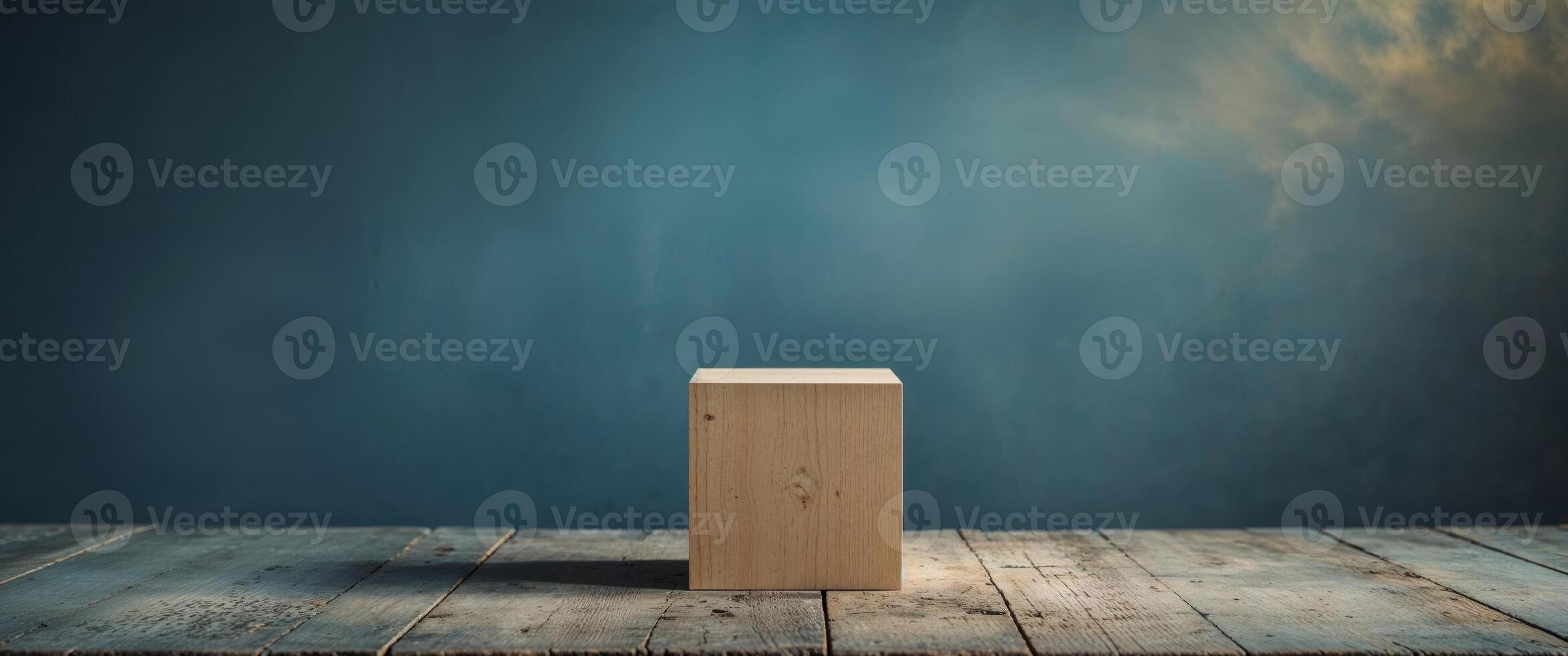A wooden block on a wooden table in front of a blue wall photo