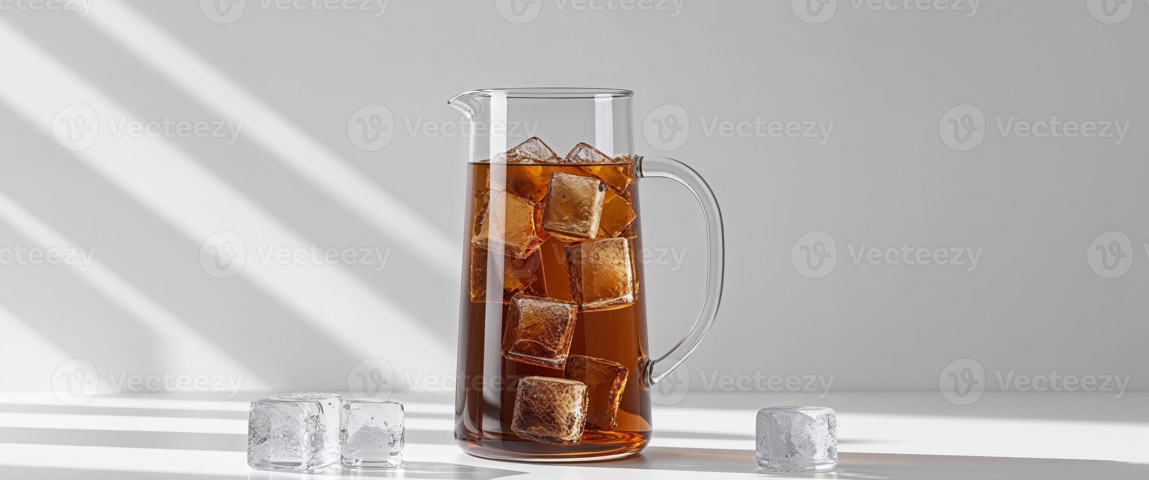 A pitcher of iced tea with ice cubes photo