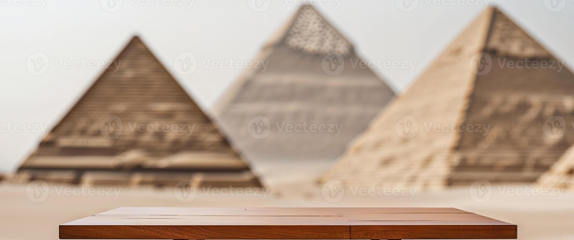 Wooden Table with Blurred Pyramids Background Creates a Serene and Ancient Atmosphere. photo