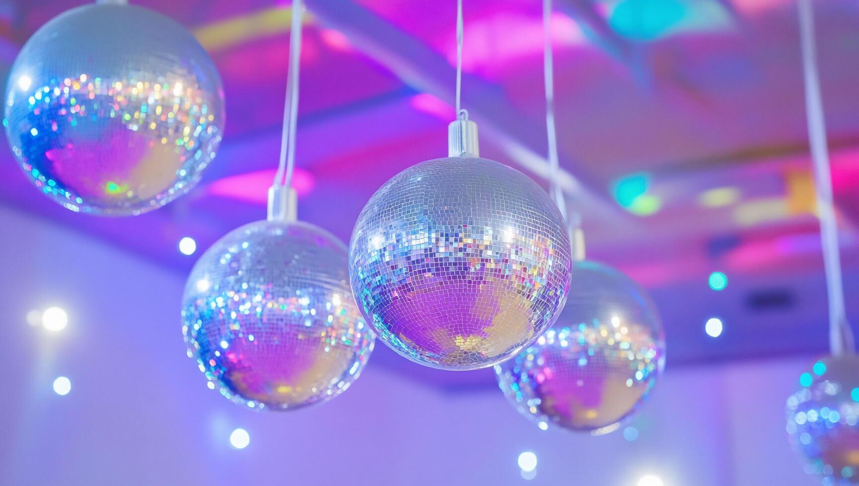Shimmering disco balls hanging in a vibrant, colorful setting. photo