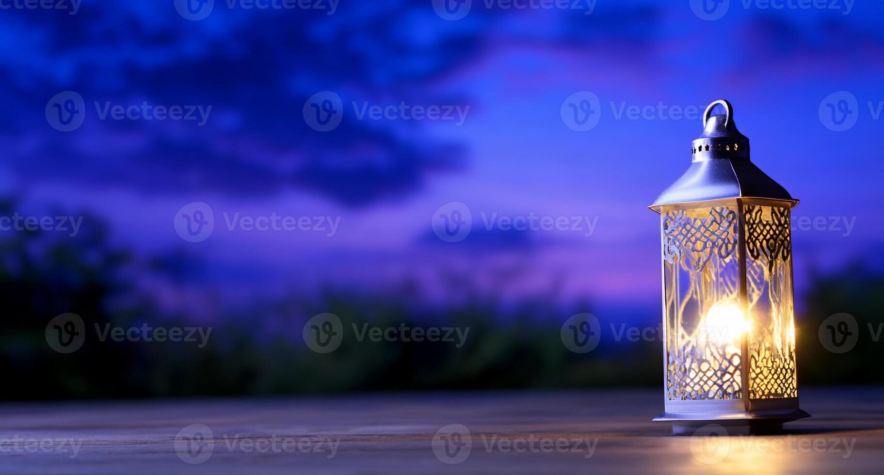 A decorative lantern emits a warm glow against a twilight backdrop. photo