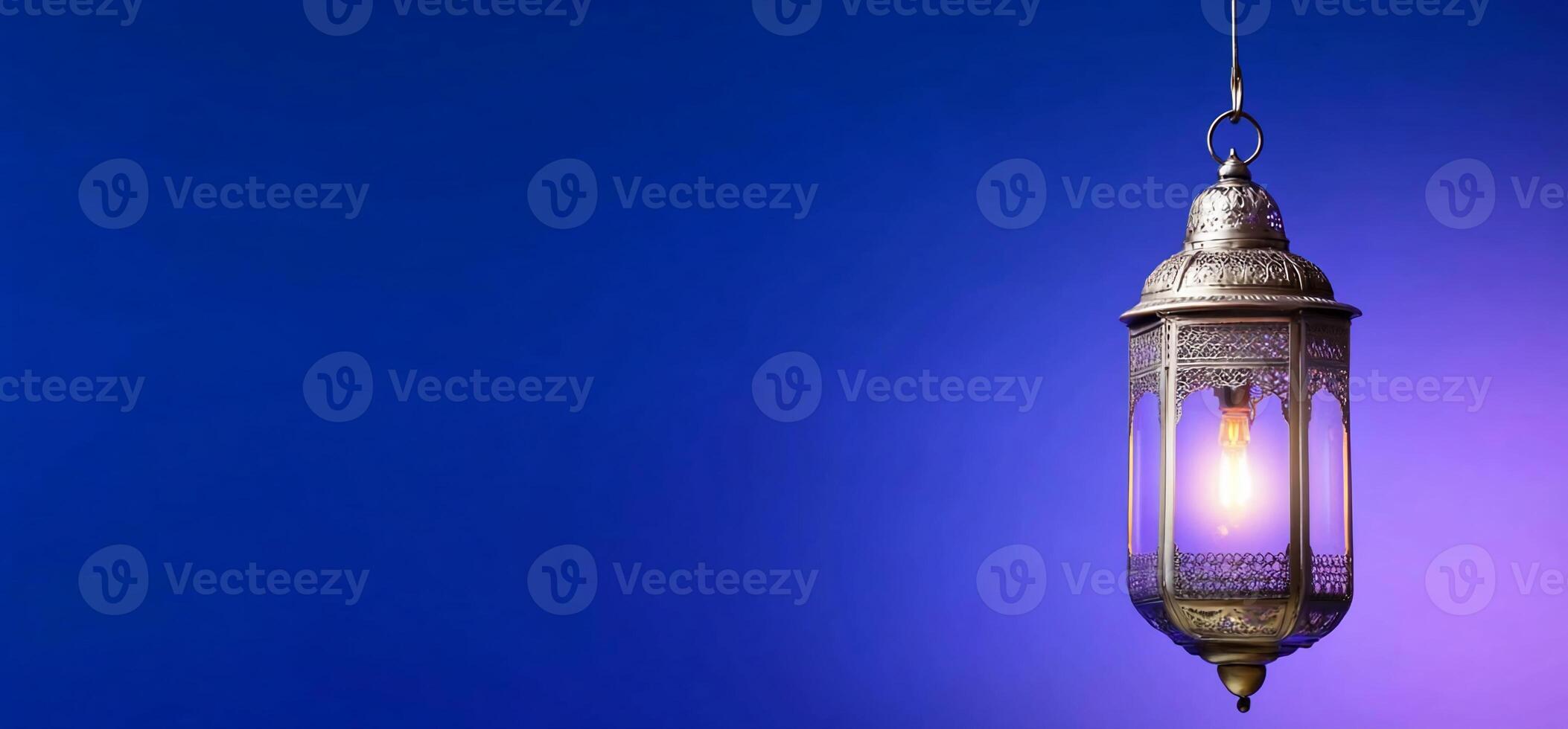 A decorative lantern hanging against a gradient blue background. photo