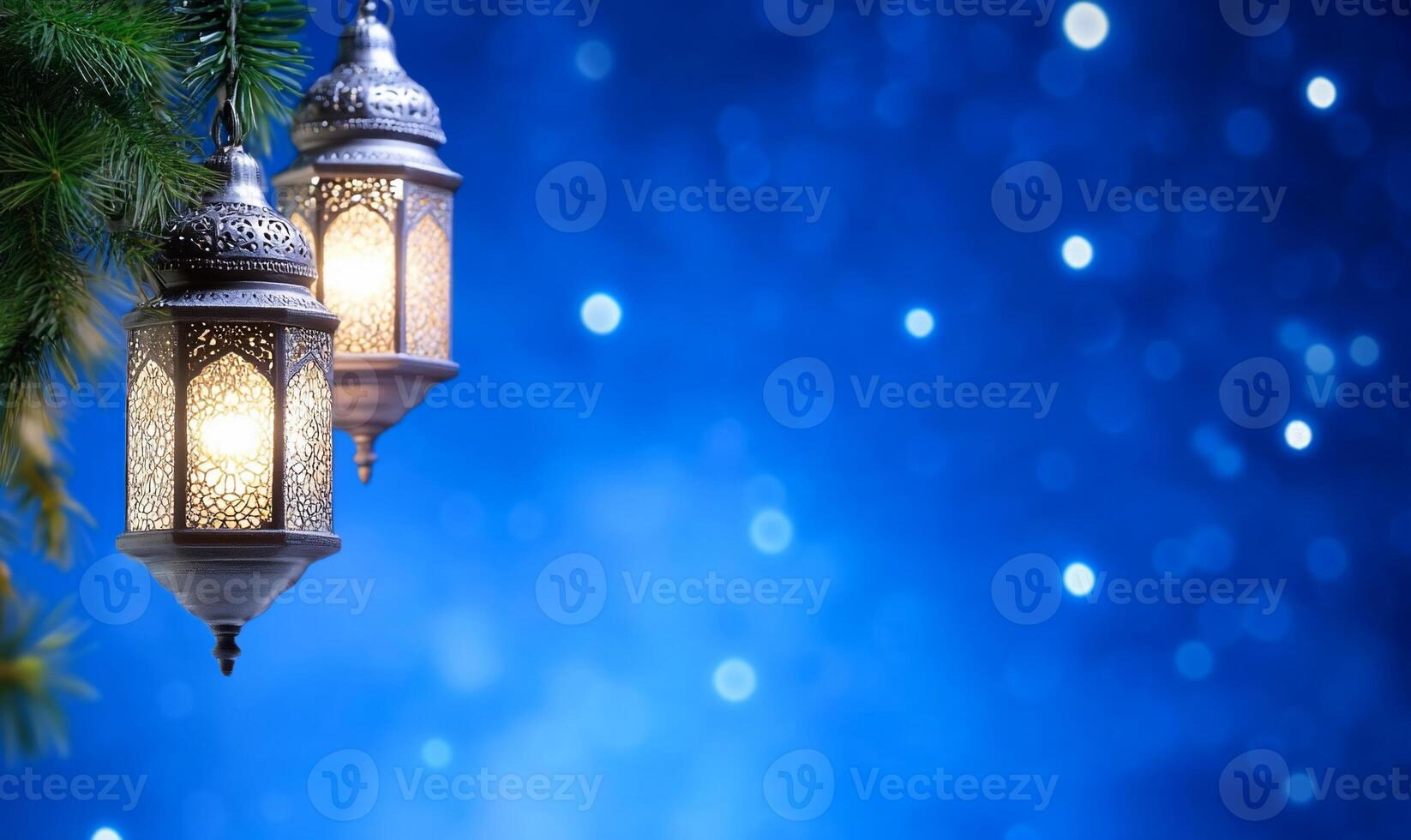 Two ornate lanterns hang against a blurred blue background. photo