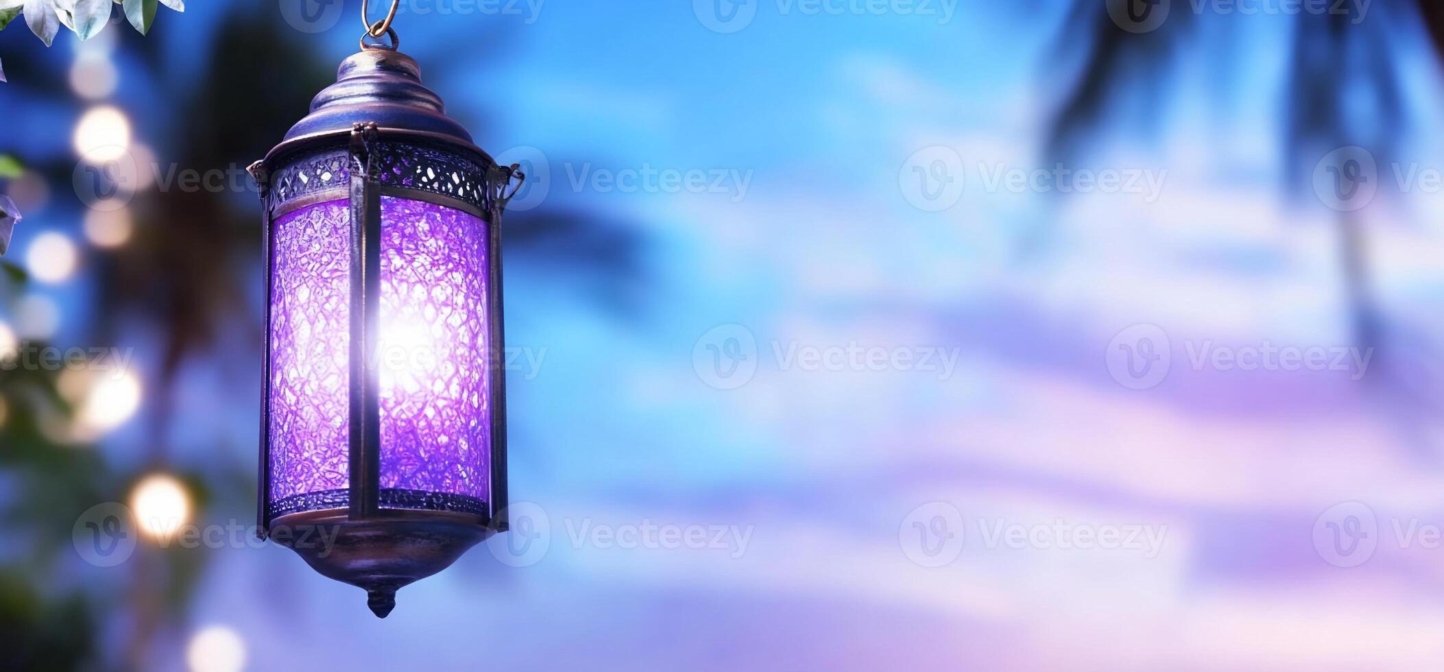 A decorative lantern illuminated against a colorful sky backdrop. photo