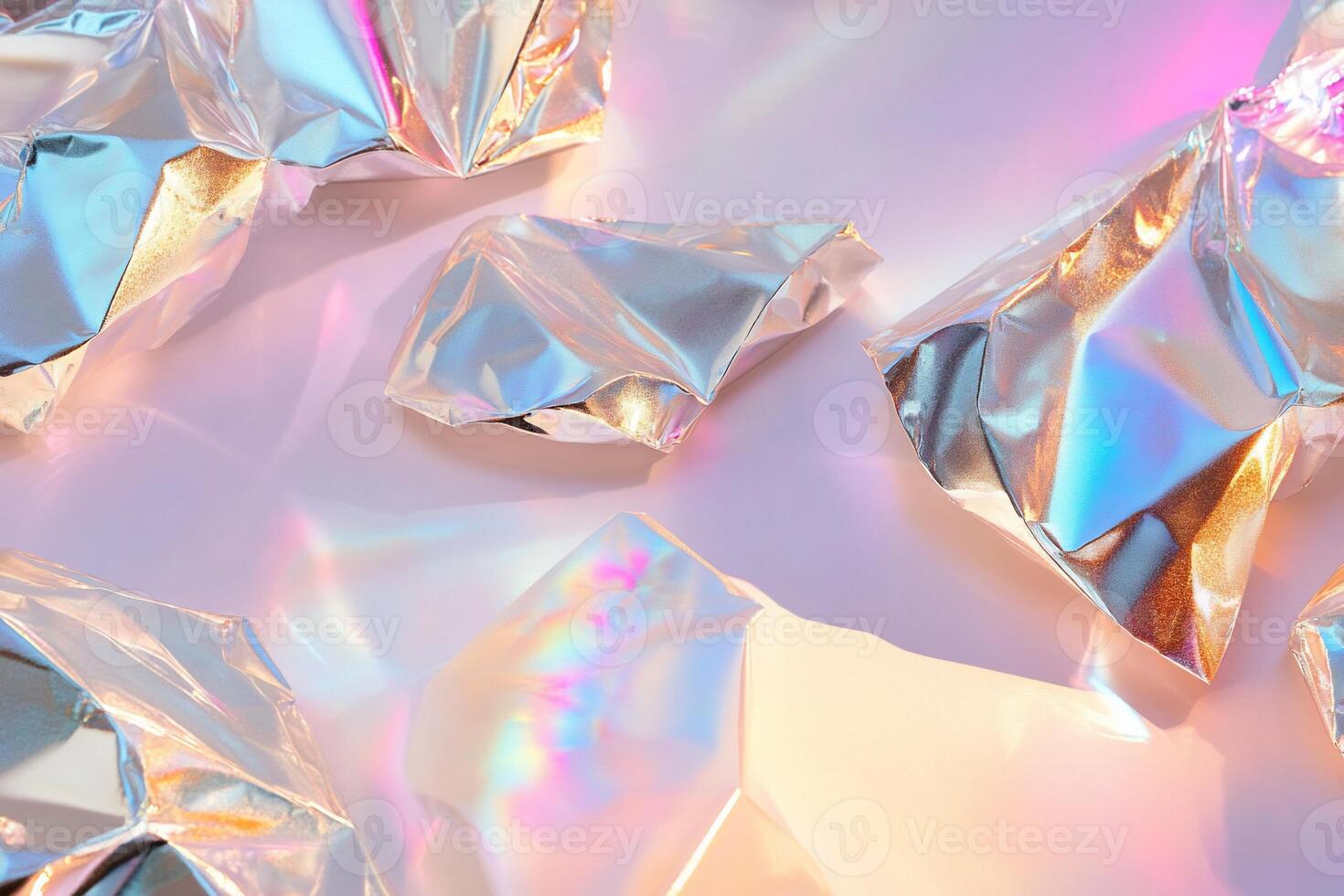Crumpled metallic foil with iridescent reflections on a light surface. photo
