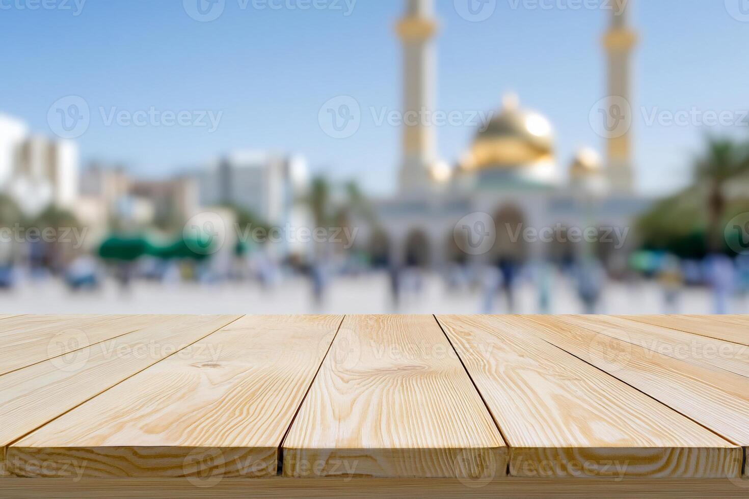 Blurred background of a mosque with a wooden tabletop in the foreground. photo