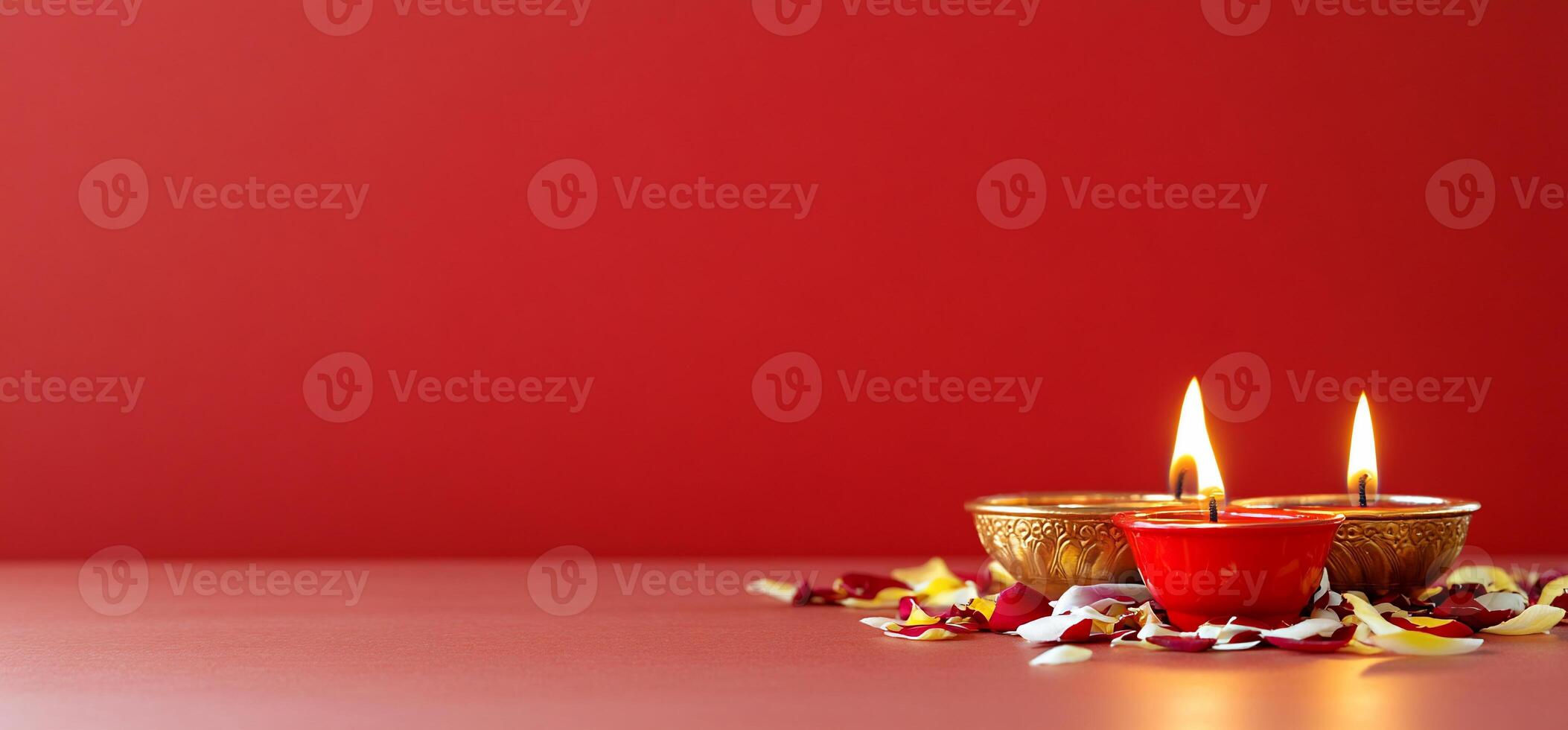 A serene display of candles and flower petals on a red background. photo