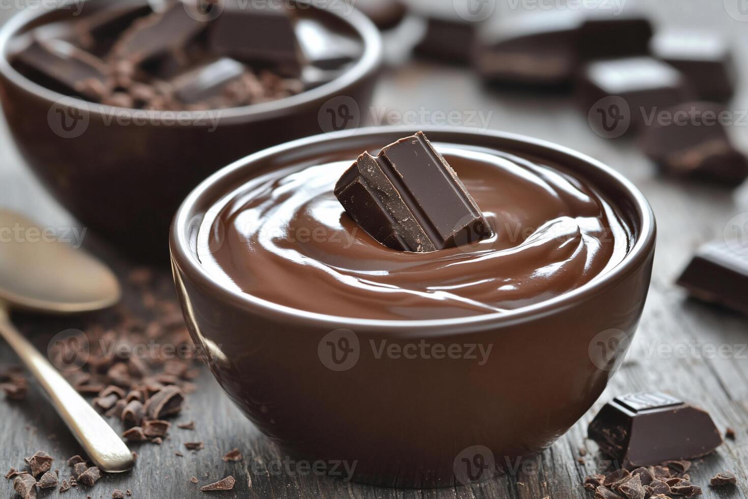 Rich chocolate pudding topped with chocolate pieces in bowls. photo